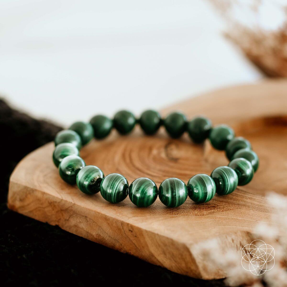 Conscious Items green stone anxiety relief bracelet with polished round beads on wooden surface