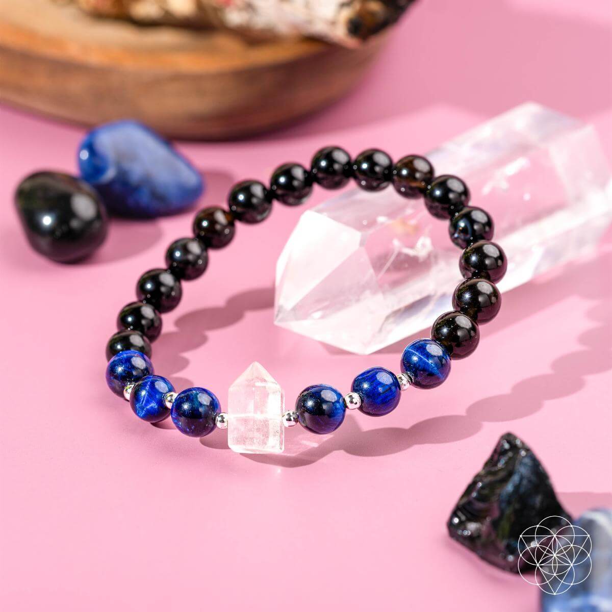 Conscious Items crystal healing bracelet for negative energy with black and blue beads and a clear quartz centerpiece
